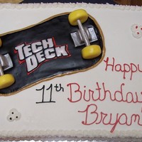 Skateboard Cake Teck Deck fondant skateboard. White and Strawberry cake with bbc icing.