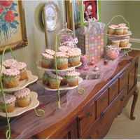 Caroline's 1St Birthday Cupcakes These are white cupcakes with white buttercream frosting and then a monogrammed sugar cookie on top.