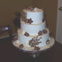 Beach Wedding Cake The cake is chocolate with white buttercream icing, chocolate seashells and royal icing coral. The sand is ground Nilla wafers.