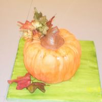 Glorious Fall Pumpkin Pumpkin raisin pound cake (2 bundt pans top to top put together), covered in satin ice rolled fondant. The flower were made with sugarpaste...