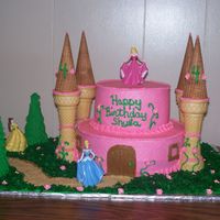 Princess Castle All white cake and Buttercream Icing. The pink flowers are Royal Icing. The Trees are sugar cones with royal leaves. The grass is coconut...