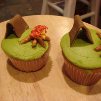 Campout Cupcakes tent made from mmf, logs are pretzels, and fire is buttercream