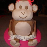 Monkey Round stacked cakes slightly carved. Covered in fondant with fondant bow