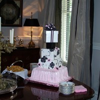 Baby Jane This is a three tier baby shower cake with pink skirting and black brushed embroidering. The box on top was done as a keepsake. The flowers...