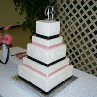 100_1756_600_X_450.jpg This cake was was my first buttercream square cake. It was made for a very sweet bride. Lucky me. She just wanted a white cake with vanilla...