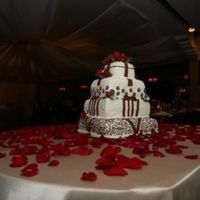 Wedding Cake Scroll Fondant with chocolate cake and chocolate mousse and buttercake with raspberry. Sugar paste roses and flowers.