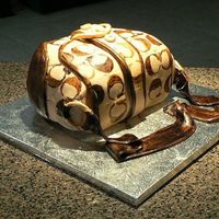 Coach Cake painted on "C"s on fondant, with a butter cake and cream filling.