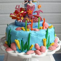 Mermaid Cake I made this cake for my daughter's 4th birthday party. Unfortunately, I did not take a picture while the cupcakes were still there....