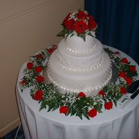 Red Roses Wedding Cake This cake was made in May 2004 using white fondant. The top and bottom tiers displayed a simple pearl pattern, and the middle tier was...