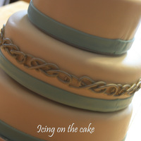 Celtic "ring Of Eternity" The couple wanted a simple cake with a Celtic ring of eternity. All done in fondant. The ring around the middle tier took about two hours...