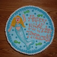 Mermaids Birthday Cake The mermaid is made entirely from fondant, brushed with white and violet lustre dust to giver her a shimmery loonk. The sides of the cake...