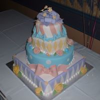 Dscf0031.jpg Everything on this cake is edible, except for the flower wires in the gumpaste bow. The design of this cake is based on a design by Sharon...