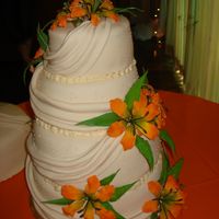 Drapes & Flowers Fondant drapes and orange gumpaste flowers for a quinceanera party.