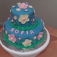 Flower Birthday Cake Covered in fondant and fondant daisies. For my nieces 2nd birthday. Trim in royal icing (green) as grass.