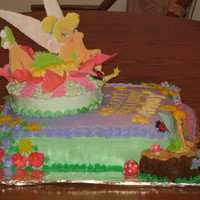 Tinkerbell Cake Buttercream frosting, gum paste lady bugs and mushrooms, rolled fondant flower, colorflo Tinkerbell, log made from marshmallows covered...