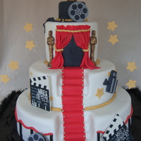 Hooray For Hollywood 3-Tier covered in BC then fondant. Statues are chocolate molds dusted with gold luster dust. All other decor items are made of fondant.