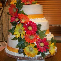 Wedding Cake I had a hard time with this cake because the flowers the bride brought me were so big. I used ivy and leaves to help tie it all together....