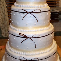 Wedding Cake I had a lot of fun with this cake. I did find it a little difficult to put the top ribbon on straight. There is a topper (letter N in brown...