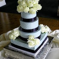 Grey With Swiss Dots Grey buttercream with swiss dots. Fresh flowers. It's 12, 10, 8, 6.