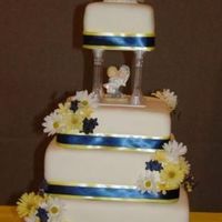 4 Tier Square Wedding Cake I made this cake for my cousin's wedding. It is white and chocolate cake covered in buttercream and fondant. Ribbon and flowers are...