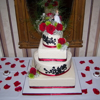 Red & Black Wedding Cake Tier's are 6,8,12 & 14. Chocolate cake w/ whipped choc ganache & Vanilla w/ white chocolate cream, Buttercream icing. Used my...