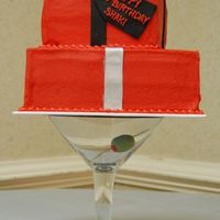 Martini Glass Gift Boxes 2-tier gift boxes iced in red buttercream with fondant ribbons and bow. Cake was set atop a giant martini glass with a fondant olive inside...