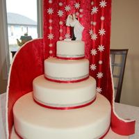 Tiered Wedding Cake - Not Edible This is cake is covered in fondant and is not edible. The shower of flowers are made of fondant too. The cake plate is covered in fondant...