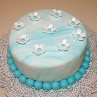 Teal Themed Fondant Cake Marbelized fondant covered cake, team theme, fondant flowers brushed with pearl dust.