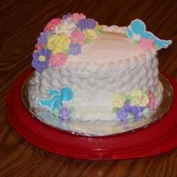 Wilton Course 2 Final Cake Basketweave is Buttercream. Flowers are made from Royal icing. Birds are color flow.
