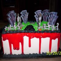 Halloween Birthday Cake This was A cake I made for my Sis-In-Law's Dad's Birthday. The headstones are candles, and the "Blood" is tinted Piping...