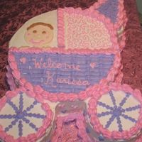 Baby In Carriage This was a baby shower cake. A very large one. It's Two 12" stacked, and 2 6" stacked for the wheels. Took FOREVER!