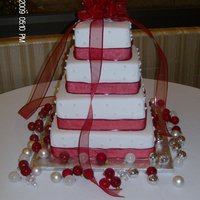 Christmas Square Fondant Wedding Cake 4 Tier Square wedding cake made with cream cheese buttercream and fondant. Stars made out of gumpaste and dragees with pearl dust. Red silk...