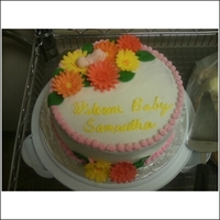 Baby Shower Cake I did for a baby shower I made out of buttercream frosting and gerber daisy made out of fondant and gumpaste.