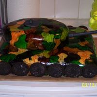 Brett's Tank Hand painted camo on fondant. all fondant accents oreo wheels. Made as a gift for a 9yr little boy. What a blast this cake was to make!!...