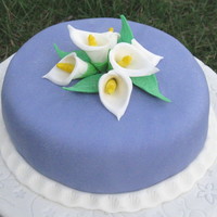 Calla Lily And Fondant Covered in purple fondant. Calla Lily and leaves from gum paste.