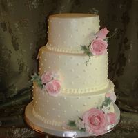 Romantic Wedding Cake White cake with vanilla BC..Covered in IMBC, with sugar roses, stephanotis and ivy.