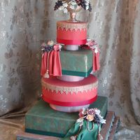 Tuscan-Themed Wedding Cake Fondant-covered tiers with fondant trim, drapes, cords and tassels. All flowers and the vase are made from sugarpaste. Separators are...