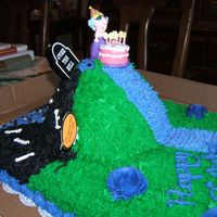 Over The Hill 1/2 sheet cake with doll cake bottom placed on the top. The icing is all buttercream. The idea of the decoration was that one side is...