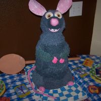 Ratatoullie Remy Carved from six 8" round cakes, stacked. Head is made from rice krispy treats. Eyes, nose, and tail are mmf and ears are gumpaste....