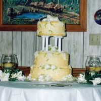 First Wedding Cake I made this cake for my father's wedding. It is vanilla cake with buttercream frosting and buttercream white roses and yellow scrolls...