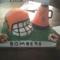 White Bluff Bomber Banquet Helmet is carved out of 1-9" and 3- 8" rounds stacked then iced in b/c and covered in fondant. Megaphone is carved out of about 6...