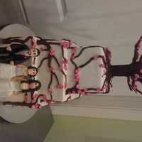 Wedding Cake Pink Azaleas Square tiered wedding cake iced in white buttercream, with winding pink azalea branches and a flowering tree on top! Figurines of the bride...