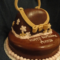 Brown Purse Cake A simple purse cake. Decorated with gum paste and chocolate fondant.