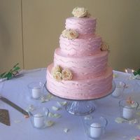 Pretty In Pink Pink buttercream icing over 4 layers of different flavoured cakes. The pink was a perfect match to the bridesmaids dresses. The sidework...