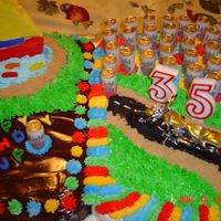 Cake For Jp This was for my daughter's boyfriend's birthday. He likes boats, fishing, motorcycles and bud light. The beer cans are candles.
