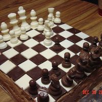 Chess Game Cake This is the cake I made for my grandson's birthday. The chess board and pieces were made in candy molds. The cake was chocolate with...