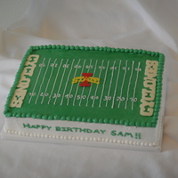 Football Field choc 1/4 sheet cake iced in buttercream. Logo done in choc transfer, candy melts for the endzone