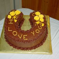 Horseshoe Grooms Cake Horseshoe grooms cake, marble with buttercream roses on chocolate buttercream icing