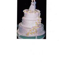 Daisy Wedding Cake 3 tier, 3 flavor cake decorated with a daisy cascade and swiss dots in buttercream