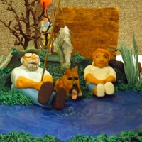 Dad's Birthday "Dad" and "Mom" and their dog "Izzy" are fondant, gumpaste accessories, the water is buttercream with piping...